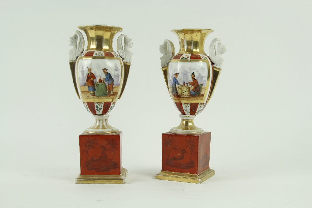 A pair of 19th Century French porcelain two handled Urns, each decorated in the chinoiserie style