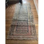 An Afghan Rug, with rows of octagons on a faded ivory field with a multi banded border,approx. 10'7"