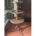 A late Georgian period circular mahogany three tier Dumbwaiter, with turned pillar supports on a