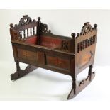 An 18th Century oak Child's Rocking Cradle, the pierced ends with turned balustrades, above star