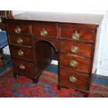 A George III period mahogany and crossbanded Bachelors Desk, with an arrangement of nine drawers