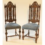 A set of four 17th Century style carved oak high back Side Chairs, each with floral crest above a