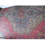An Oriental style machine made Carpet, with large centre medallion crimson ground and stylized