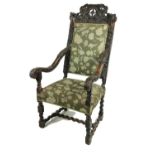 An early 19th Century Cromwellian style walnut high back Armchair, the shell and leaf crested top