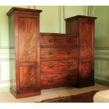 An early Victorian Irish mahogany Wardrobe Chest, the sunken centre with an arrangement of four long