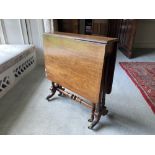 A William IV period inlaid walnut Sutherland Table, the rectangular top with two drop flaps, on a