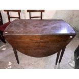 A George III period mahogany drop-leaf Dining Table, with demi-lune flaps flanking a frieze drawer