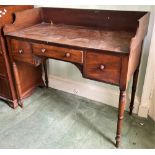 A William IV period mahogany kneehole Dressing Table, with three-quarter gallery and three frieze