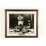 Signed by Muhammed Ali Boxing: A large black and white Photograph, Muhammed Ali knocking out Sonny