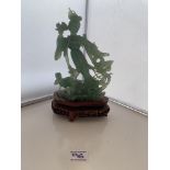 Green jade figure on wooden base. 9” (23cm) total height . Some chips and damage