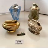 4 assorted vintage table lighters: 1 onyx, 1 blue glass, 1 plated and 1 gold/black, and miniature