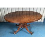 Oval walnut dolphin legged loo table, slight damage to top edge. 32” (81cm)wide x 43”(109cm) deep