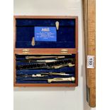 Boxed mathematical instrument set by W. H. Harling and folding wooden ruler