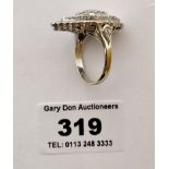 Large 18k white gold and diamond cluster ring of round and baguette diamonds, w: 12.3 gms, size S