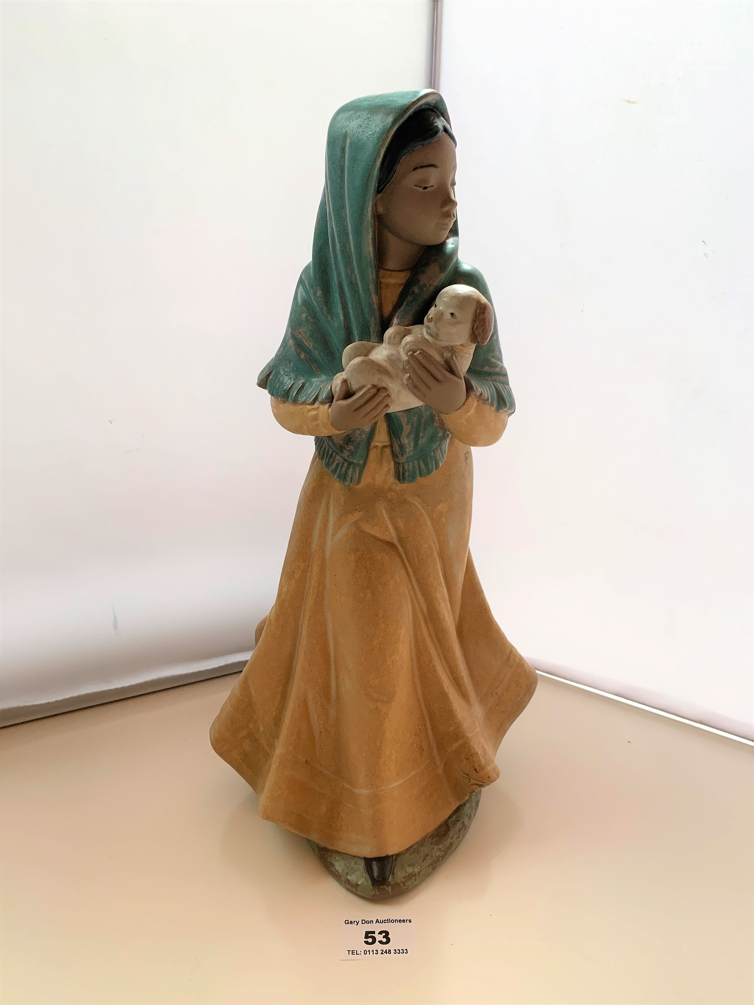 Nao figure of woman with puppy, 13.5” (34cm) high. Matt finish, distressed look. No damage