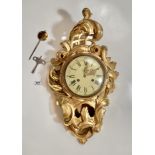 Reproduction gilt wall clock marked Atlantic with key and pendulum. 24” (61cm) long x 14” (35cm)