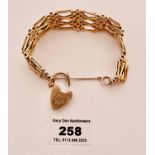 9k gold gate bracelet with heart lock, w: 28.7 gms, length 7” (18cm)