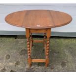 Drop leaf twist leg table. 24” wide, 28.5” high, 14.5” deep (35” open). Slight wear to top.