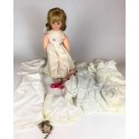 Modern porcelain doll on stand with clothes and linen, 18” long