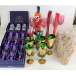 Assorted coloured glasses including boxed set of 6 RCR crystal champagne flutes, boxed set of 6