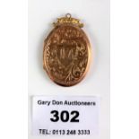 9k gold front and back locket with old photographs, length 1.5”