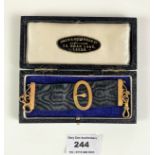 9k gold and ribbon medal holder in box. Length 6”