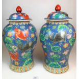 Large pair of lidded oriental vases with fish design, 19” high. No damage