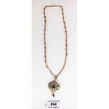 9k gold necklace with seed pearl and purple stone pendant. Length of chain 17”, pendant 2”. Total w: