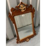 Chippendale style mahogany wall mirror with gilt painted slip and detail. 29” high, 17.5” wide
