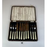 Cased set of 6 stainless steel and cream handled cake knives and forks