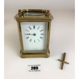 Brass carriage clock by R & Co. Paris. 4.25” high plus handle. Working with key