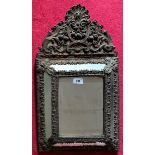 Continental giltwood carved wall mirror, rectangular mirror surmounted with carved top. Total height
