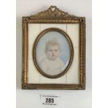 Miniature oval painting of child in gilt frame with ivory inlay, signed. Frame 4.5” x 6”