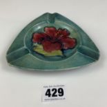 Green Moorcroft hibiscus pattern ashtray, 5” triangular. No damage