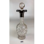 Silver topped cut glass decanter with stopper. Height 13.5” inc. Stopper. Good condition