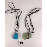 Jade pendant, length 2”, with silver mounts on leather necklace and turquoise pendant, length 1.