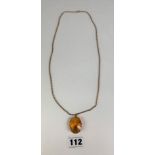9k gold necklace, length 24” with gold framed orange topaz stone pendant 1.5” length. Total weight