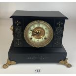 Black marble and gilt 2 hole mantle clock with ormolu mounts and white dial with gilt surround.