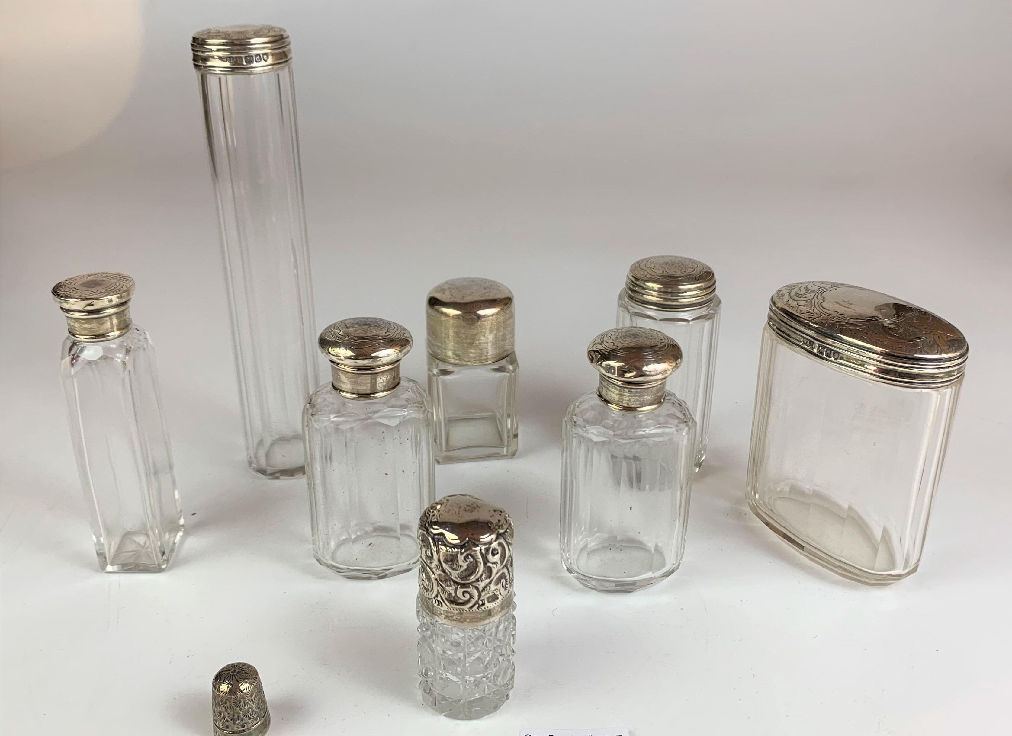 8 assorted silver topped glass bottles and silver thimble, tallest bottle 7” high