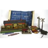 Box of tinplate railway accessories including railway station, signals, hoardings, etc.