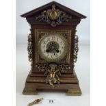Mahogany mantle clock with brass mounts and decorations in the French style with original