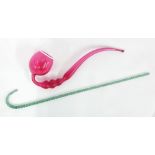 Large Nailsea type cranberry glass pipe, 20" long approx; together with barley twist glass cane