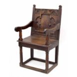Mid 17th century oak panel-back open armchair, Yorkshire, circa 1650, the cresting rail carved