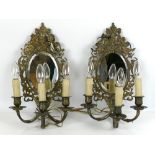 A good pair of vintage French style ornate gilt metal mirror back wall lamps each with three