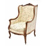 19th century French walnut fauteuil, with cream patterned upholstery, within a foliate carved