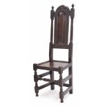 17th/18th century oak high back hall chair, with an arched fielded panelled back within carved
