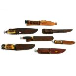 Collection of Bowie type knives within their original leather scabbards (7)