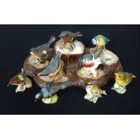 Beswick - Nine bird figures, tallest 2.75" high; together with a Beswick naturalistic tree stump