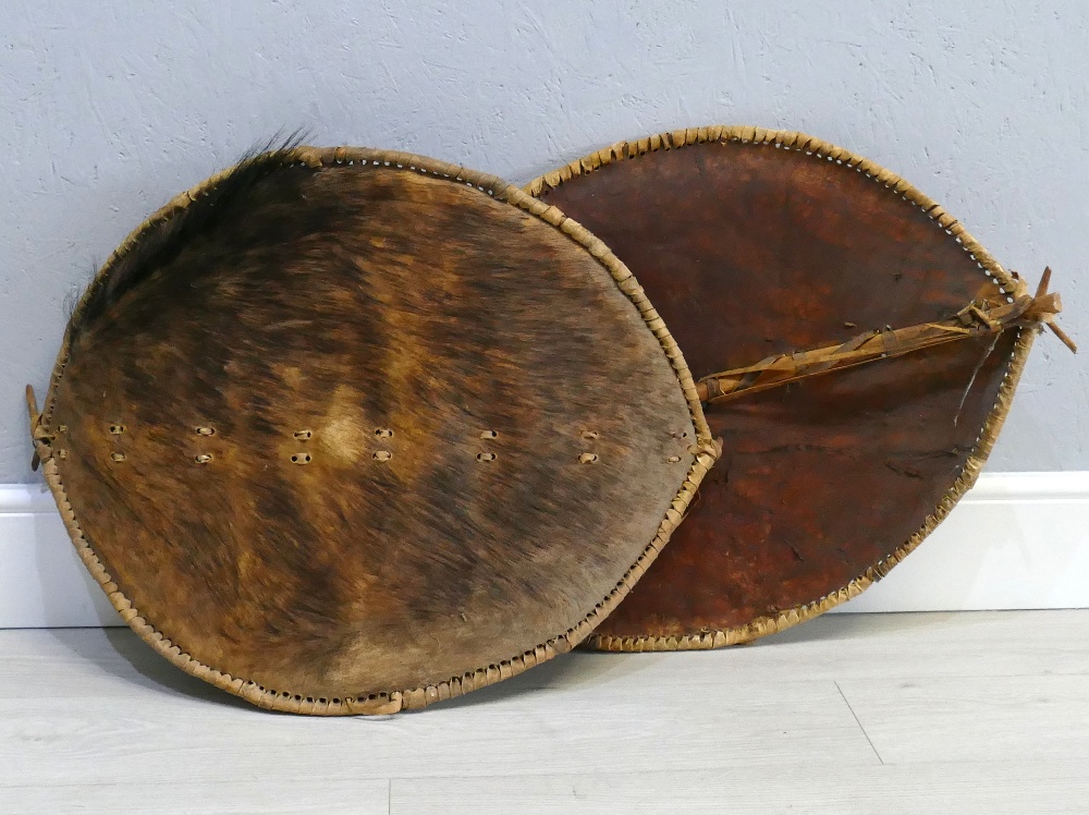 Pair of African native hide shields, 30" x 23" (2)