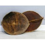 Pair of African native hide shields, 30" x 23" (2)